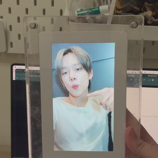 Video: KPOPIFY Poster on a desk shelf playing a K-pop idol video next to a laptop