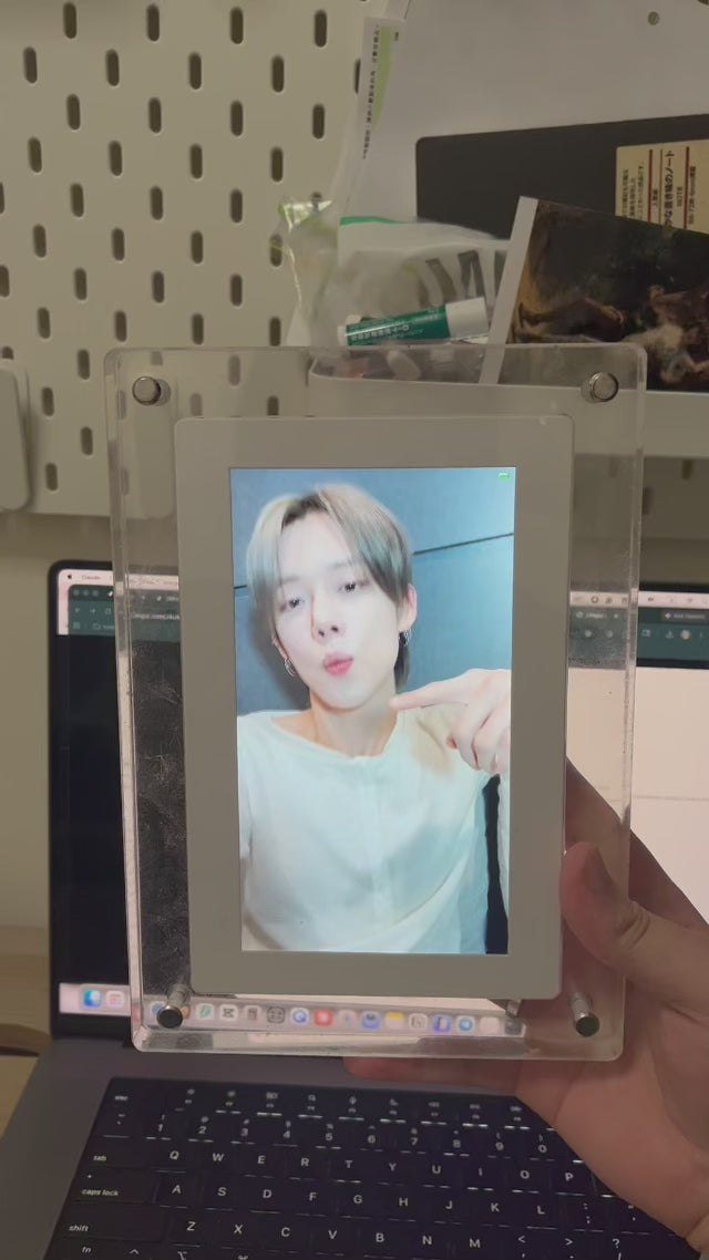 Video: KPOPIFY Poster on a desk shelf playing a K-pop idol video next to a laptop