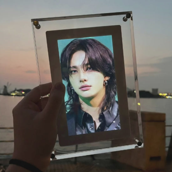 Video: KPOPIFY Poster playing a K-pop idol clip in its clear acrylic frame at dusk